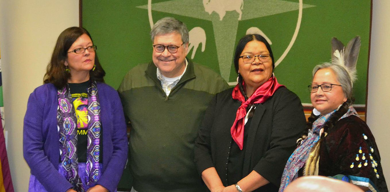 Three members of Council stand with Barr